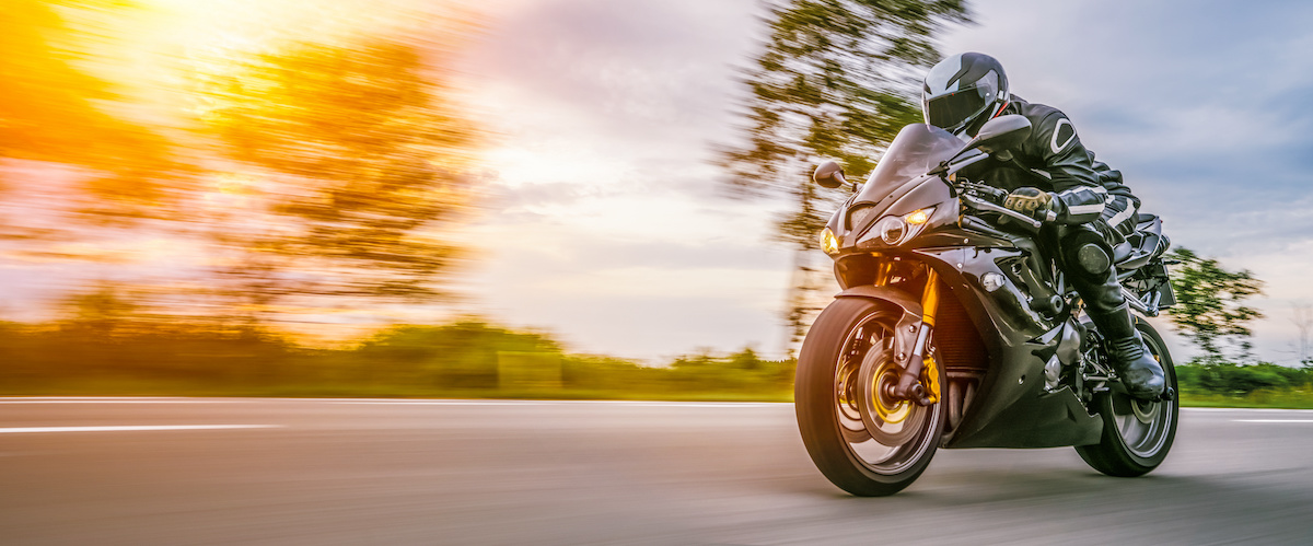 Motorcyclist riding on empty road.