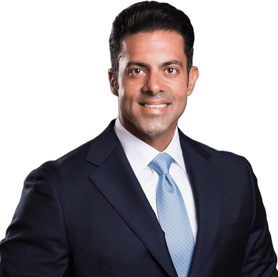 Professional headshot of a man in a navy suit and light blue tie, smiling at the camera.